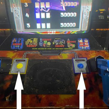 Vintage arcade shooting game with two joystick controls and a colorful display.