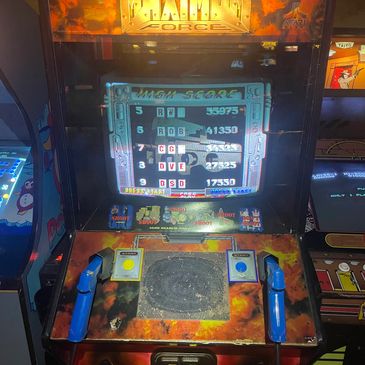 Classic arcade game "Time Force" with blue gun controllers in a dimly lit arcade.