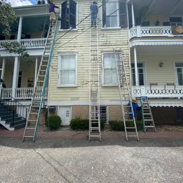 Historic Charleston home undergoing full exterior restoration by LG Painting + Construction. This project includes detailed surface preparation, paint removal, shutter restoration, wood repairs, and professional exterior painting designed to protect and preserve Charleston's historic architecture.