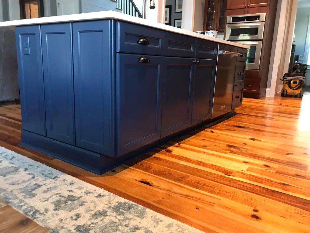 Kitchen island cabinet refinishing completed in Charleston, SC. Custom navy blue finish, updated hardware, and professional craftsmanship by LG Painting + Construction. #CabinetRefinishing #KitchenIsland #CharlestonSC #LGPaintingConstruction