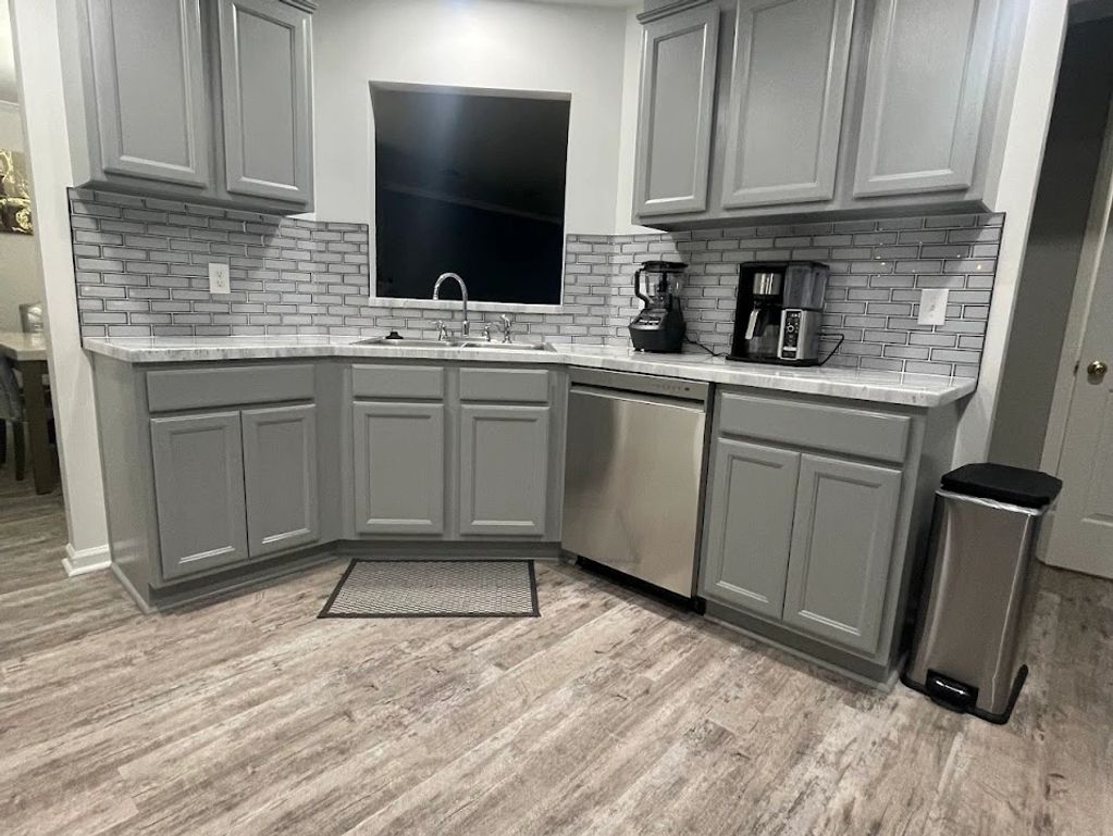 Kitchen cabinet refinishing in Charleston, SC featuring professionally painted gray cabinets, updated finishes, and a modern tile backsplash. Completed by LG Painting + Construction. #CabinetRefinishing #KitchenRemodel #CharlestonSC #LGPaintingConstructionabinet Refinishing