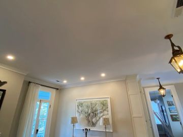 Elegant living room with recessed lighting and framed artwork.