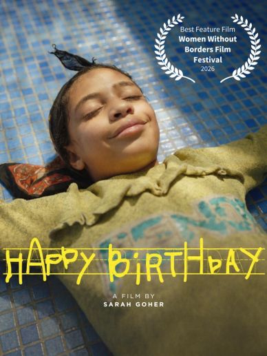 A girl lying down smiling in the film "Happy Birthday" by Sarah Goher.