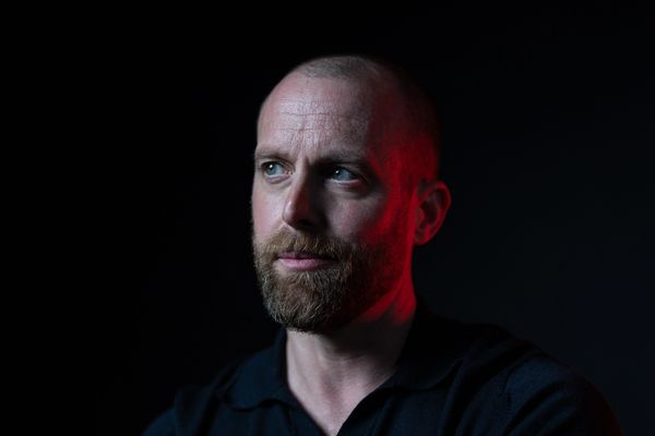 Portrait of a man with a beard in dramatic lighting.