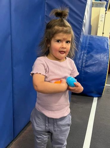 a cute little girl with toys in her hands