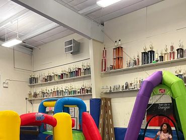 little girls are playing on the jumping house