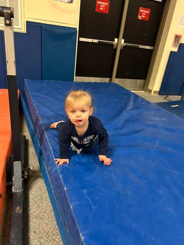 a cute little girl on the blue surface