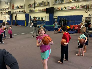 a group of kids playing basketball