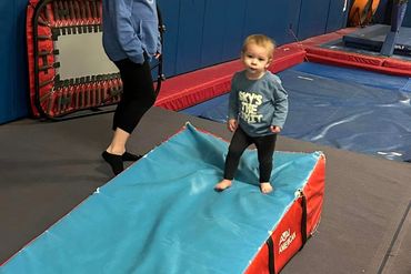 a little boy walking under a supervision