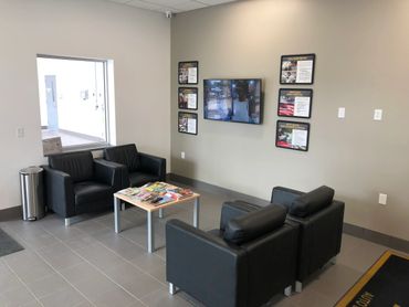 ABRA of Sioux Falls South customer lounge with chairs and TV