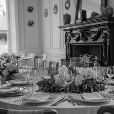 Elegant table setting with floral centerpiece in a classic dining room.