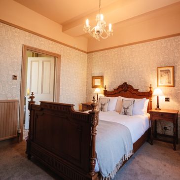 Cozy bedroom with vintage wooden bed and soft lighting.