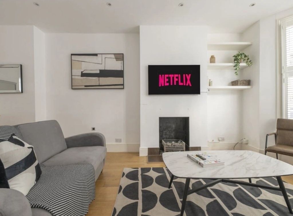 Modern living room with Netflix on TV.