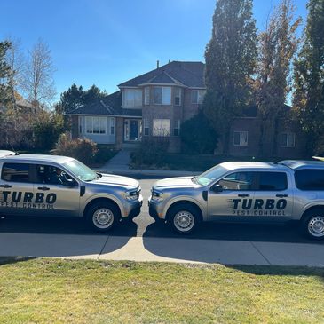 two Turbo Pest Control servicing a home