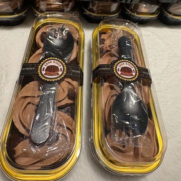 Chocolate cupcakes with edible plastic forks and spoons.