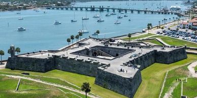 Historic fortress by the Waterfront with bridge and boats.