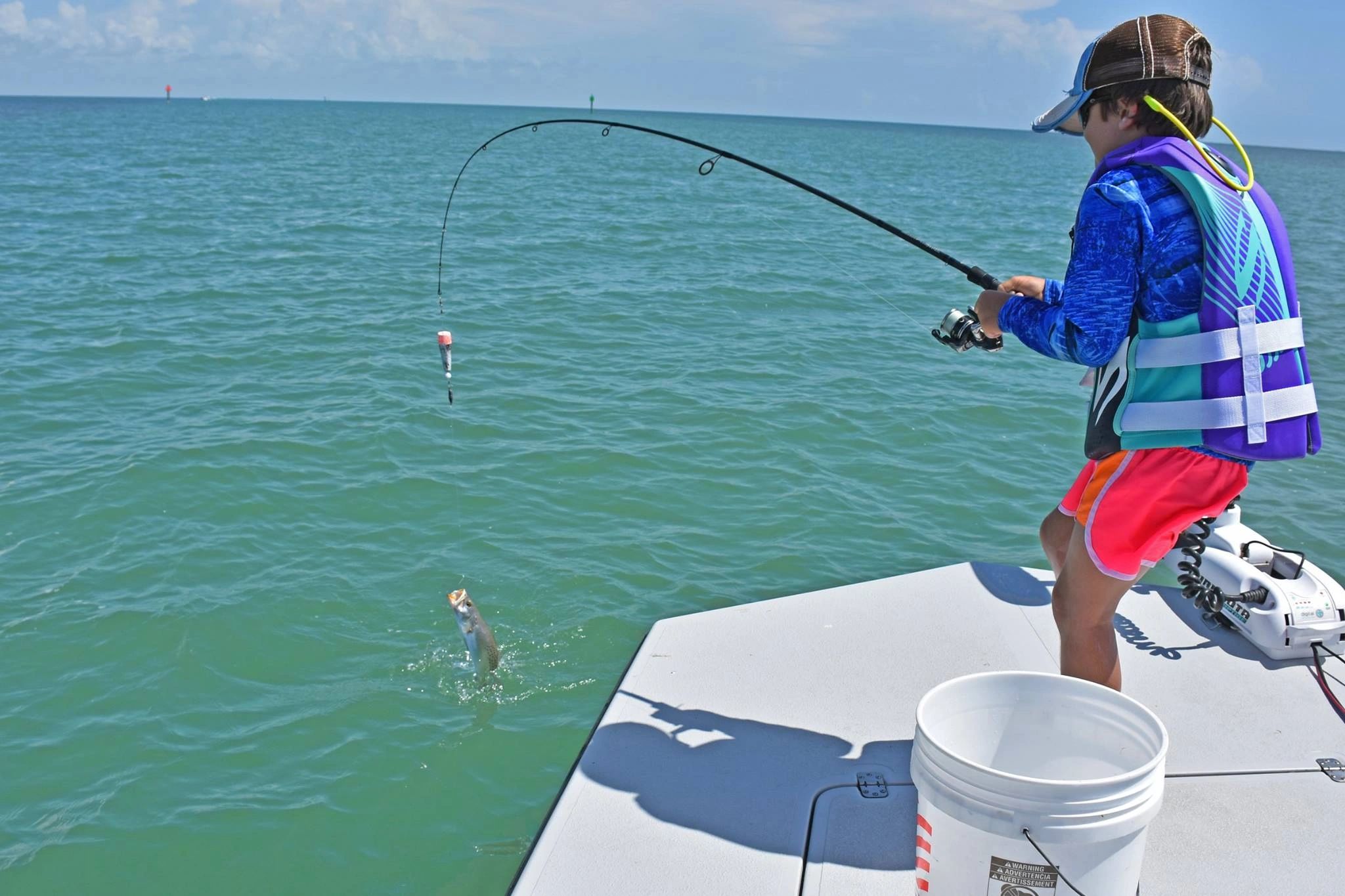 Child catching fish while bay fishing in South Padre Island with Captain Jack Barton.