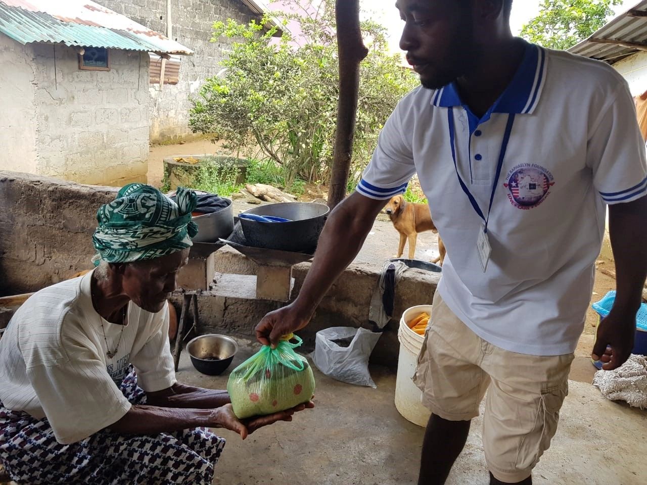 Monthly food distribution to those needing food by members of The Raphaelyn Foundation Inc (Liberia)