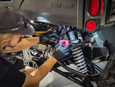 Ceramic coating being applied to the suspension of a can-am