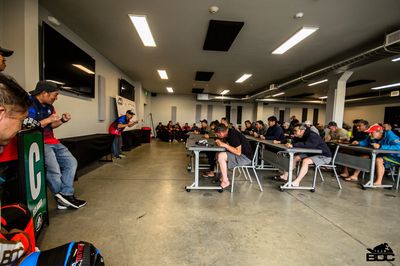 A group of people sitting and attentively listening in a classroom setting.