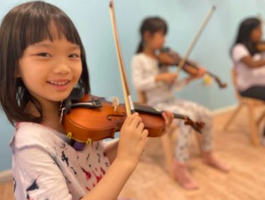 image features a young girl playing the violin