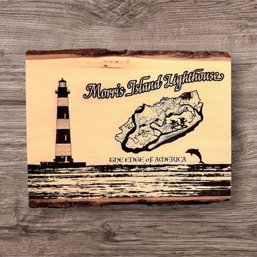 Wooden plaque featuring Morris Island Lighthouse and map with dolphin silhouette.