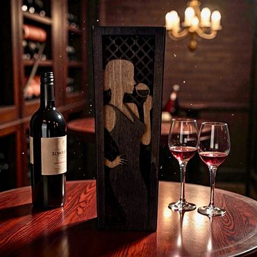 Elegant wine scene with bottle, glasses, and wooden art on table.