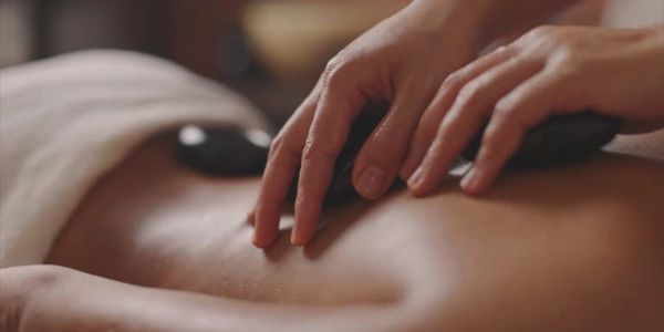 Hot stone deep tissue massage for muscle relief at Honey In Hand Spa in Bigfork, Montana