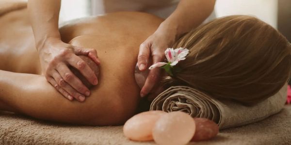 Himalayan salt stone massage on back at Honey In Hand Spa in Bigfork, Montana