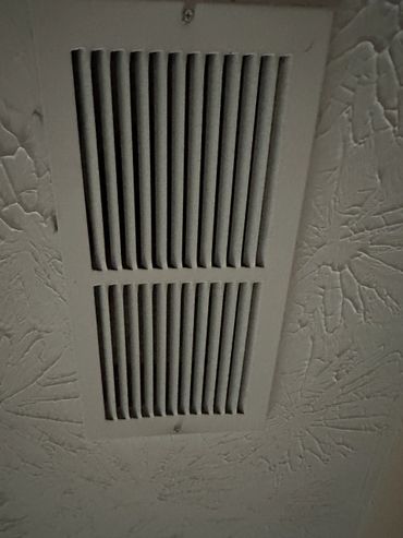 Ceiling air vent with textured ceiling.