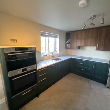 Modern kitchen with dark lower cabinets and wood upper cabinets.