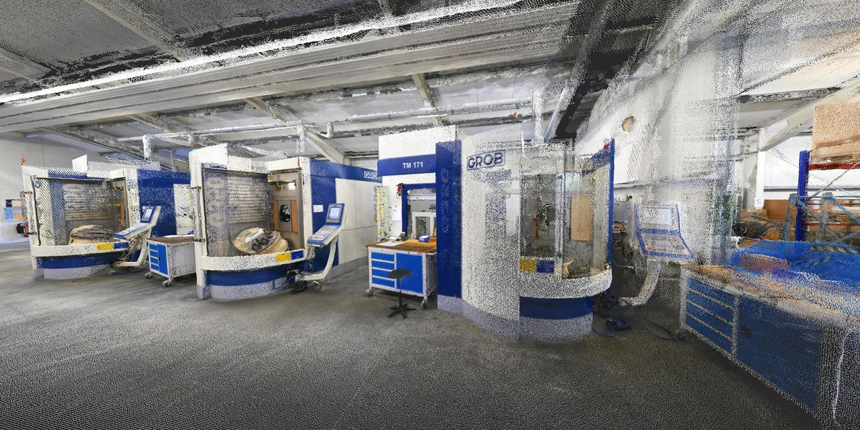 Industrial workshop with advanced GROB machining centers and workstations.