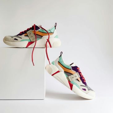 Colorful sneakers with red shoelaces on white display.