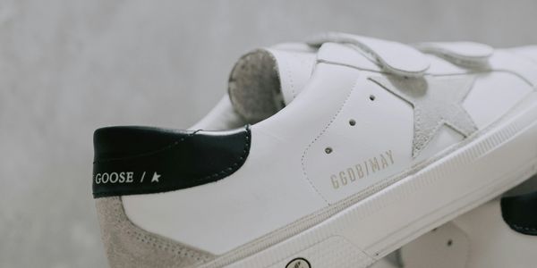 Close-up of a white and black sneaker with star logo.