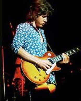 Mick Taylor playing slide guitar with the rolling stones.