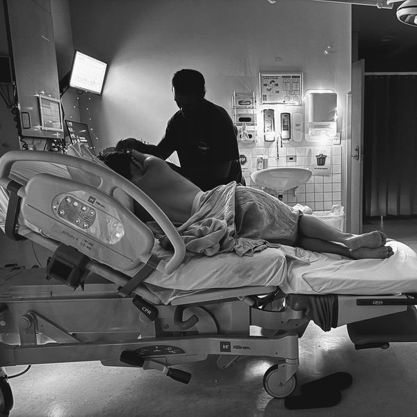 A patient and a caregiver in a hospital room.
