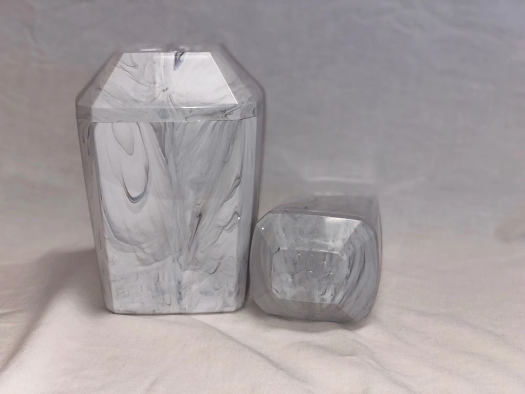 This urn is included in the private cremation price.  Plastic faux marble urn -raised print on lid.
