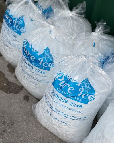 Multiple 20 lb Pure Ice Clear Water ice bags ready for a bulk ice purchase in Southwest Florida.