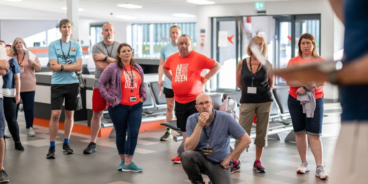 Andrew, the filmaker with a group of people at the Aberdeen Airport Runway Run.