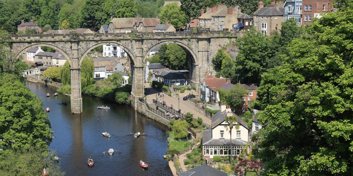 The Knaresborough viaduct spanning boating on the river Nidd.