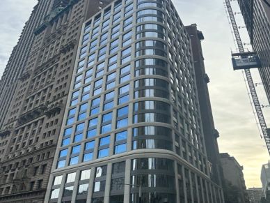 Modern glass building in an urban setting.
