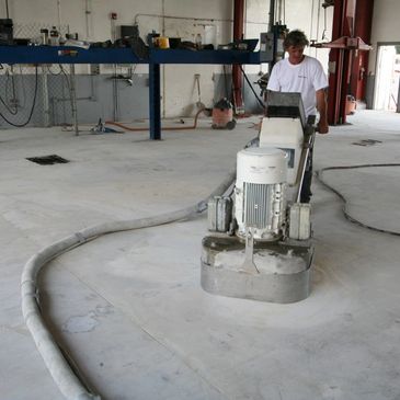 A man grinding and prepping a floor for concrete coating in MN