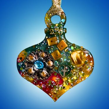 Detailed sparkling ornament with jeweled and crystal embellishments.