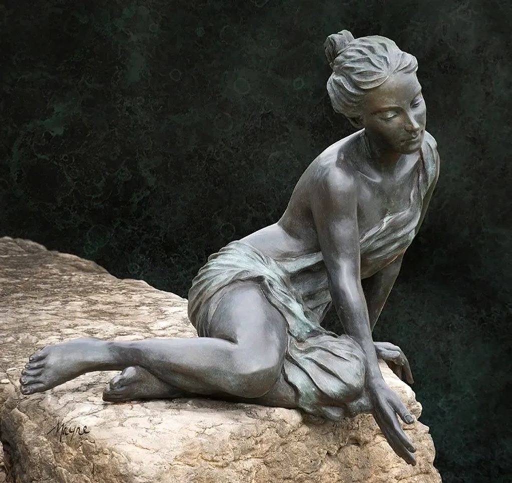 Adamaris is a seated female bronze figure. She is seen testing the water with outstretched fingers.