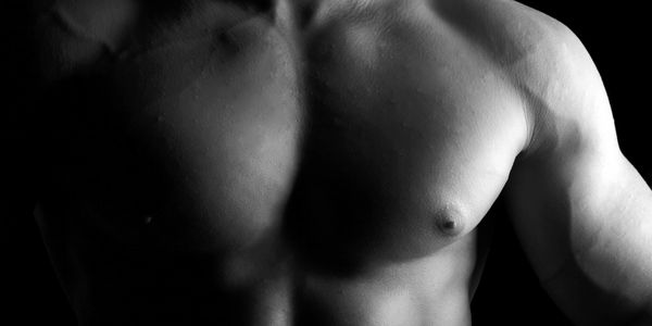 Black and white photo of a muscular male torso.