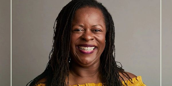 Smiling woman in yellow shares a quote about cannabis's sacred abilities.