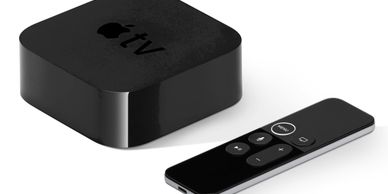 image of a black Apple TV box and remote control