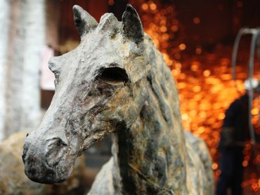 close up of cast iron pony sculpture in front of the foundry