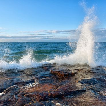 Waves crash along a rocky out crop on Lake Superior. Excellent place to see migratory birds fly over