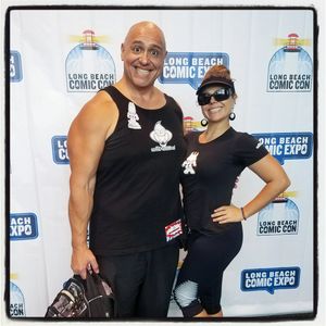Two smiling people posing at Long Beach Comic Con.